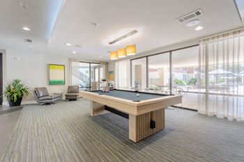 Pool table in the center of the room